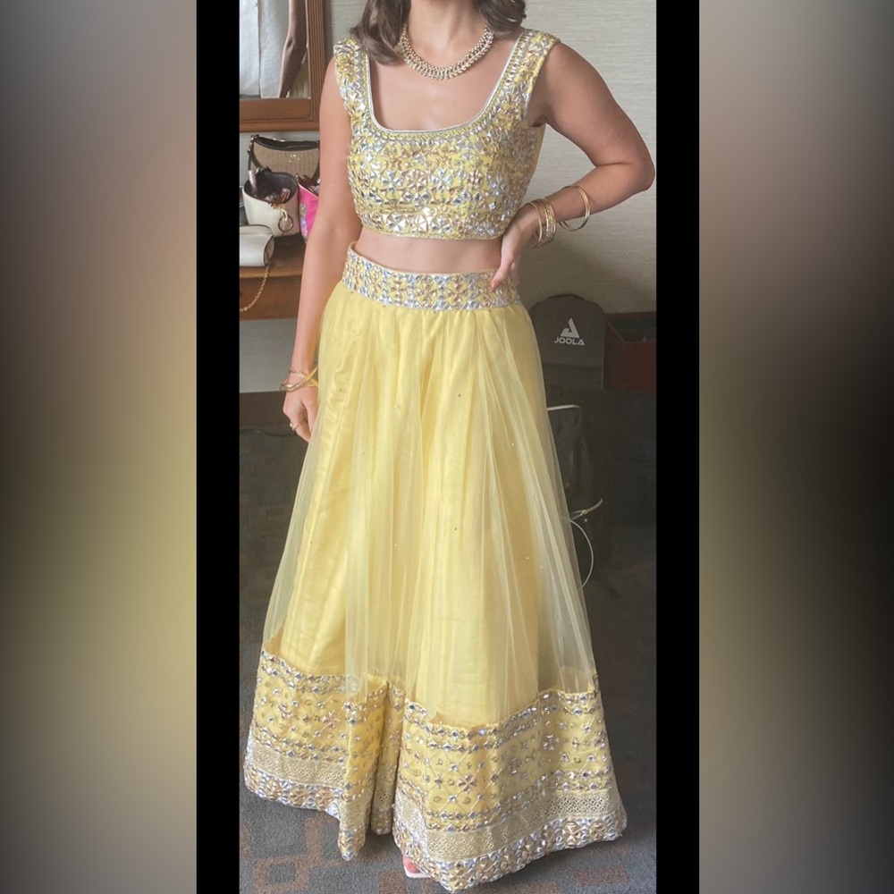 Lashkaraa yellow and pink embroidered net lehenga